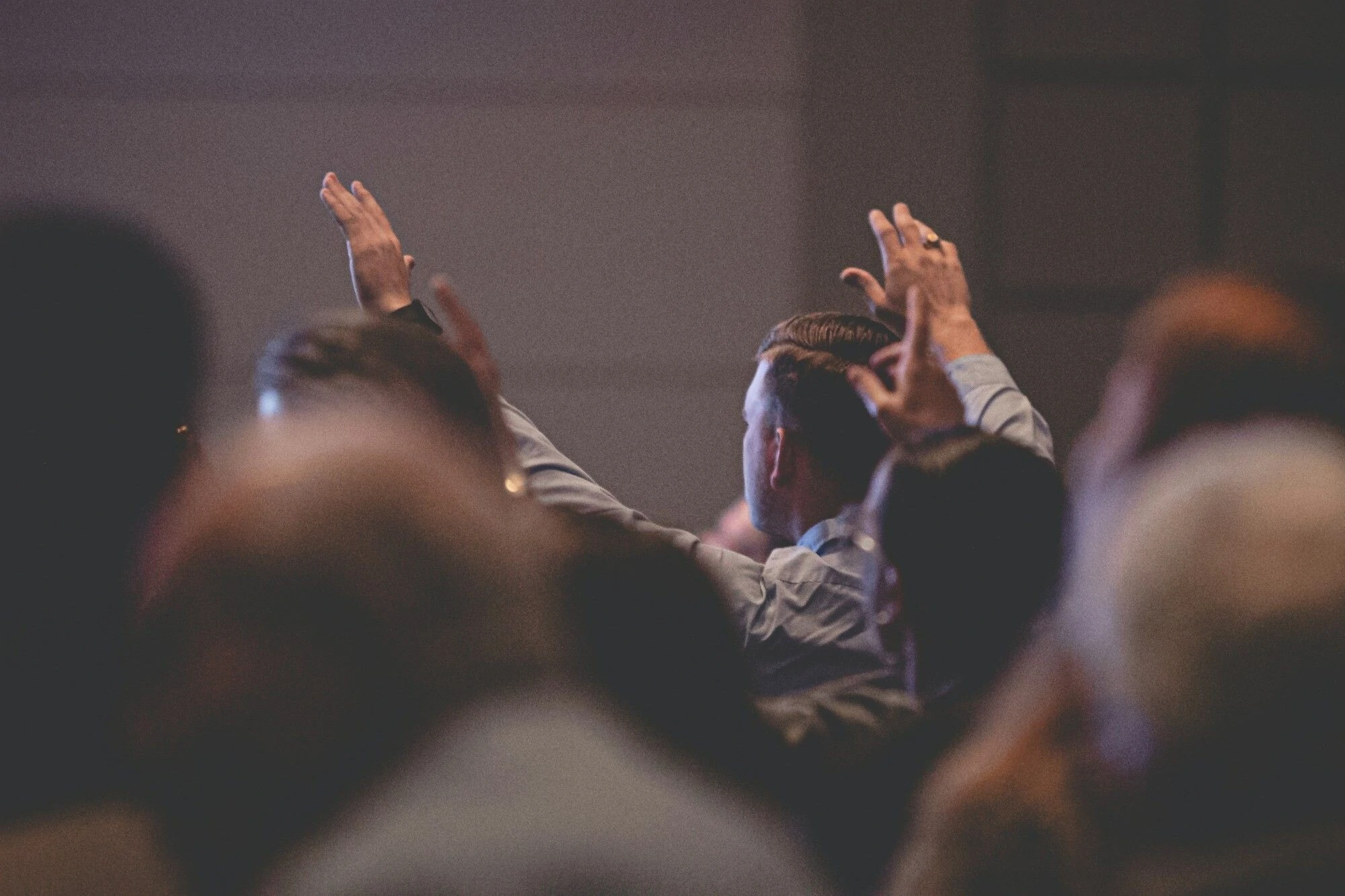 Man with hands raised in worship